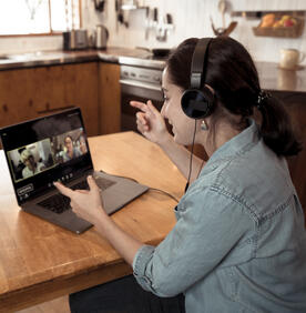 Young woman on laptop during a virtual meeting